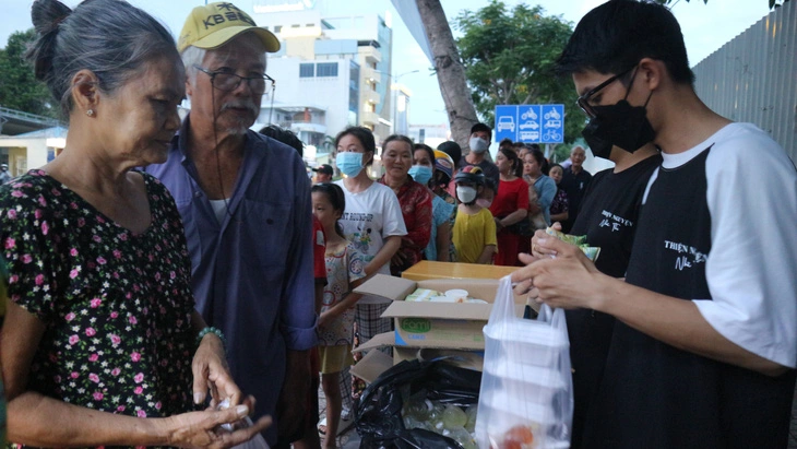 Mỗi người nhận được phần cơm đầy ụ kèm theo bánh, sữa do nhà hảo tâm tặng thêm - Ảnh: NGUYỄN HOÀNG TUẤN