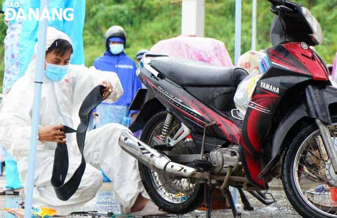 Đội SOS thay ruột xe cho người dân trên đèo Hải Vân. Ảnh: NGỌC HÀ.